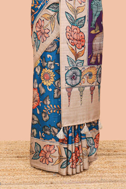 Blue art tussar silk saree with leaf and floral printed body, cream border, and floral & animal print pallu