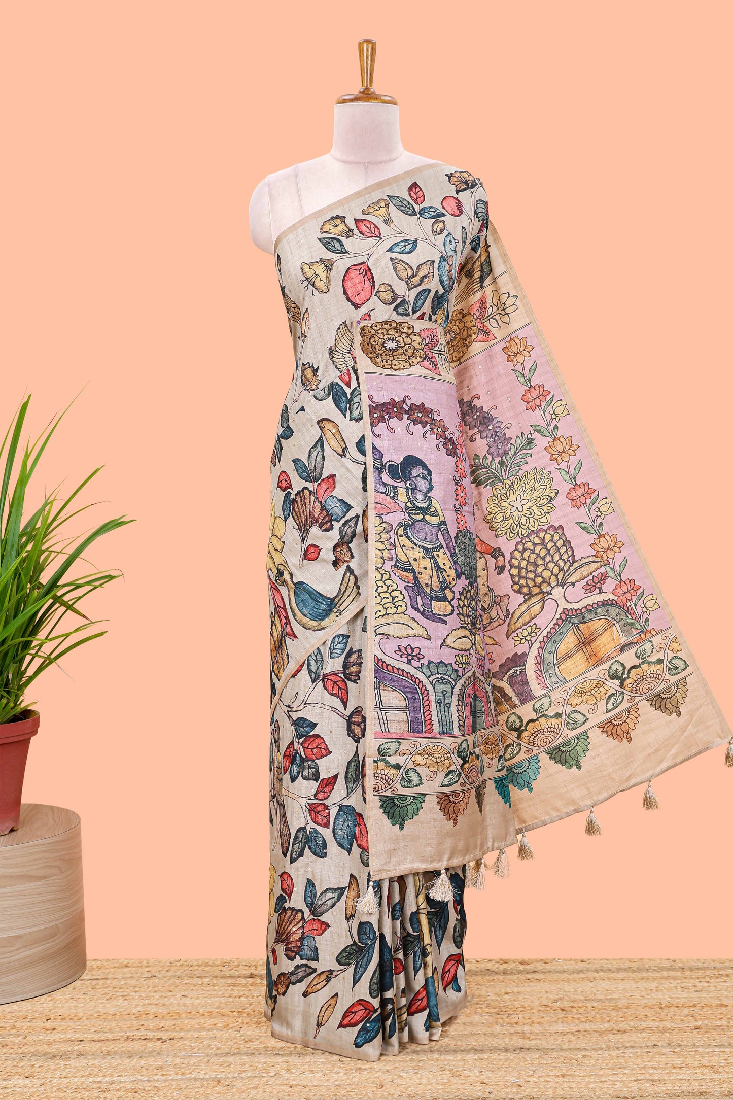 Borderless beige art tussar saree with tree, bird motifs and dancing girl printed pallu