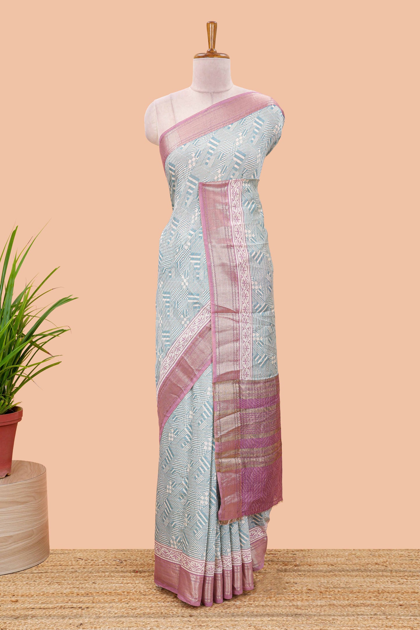 Turquoise blue assam silk saree with geometric print body, contrast zari border, and zari stripe pallu
