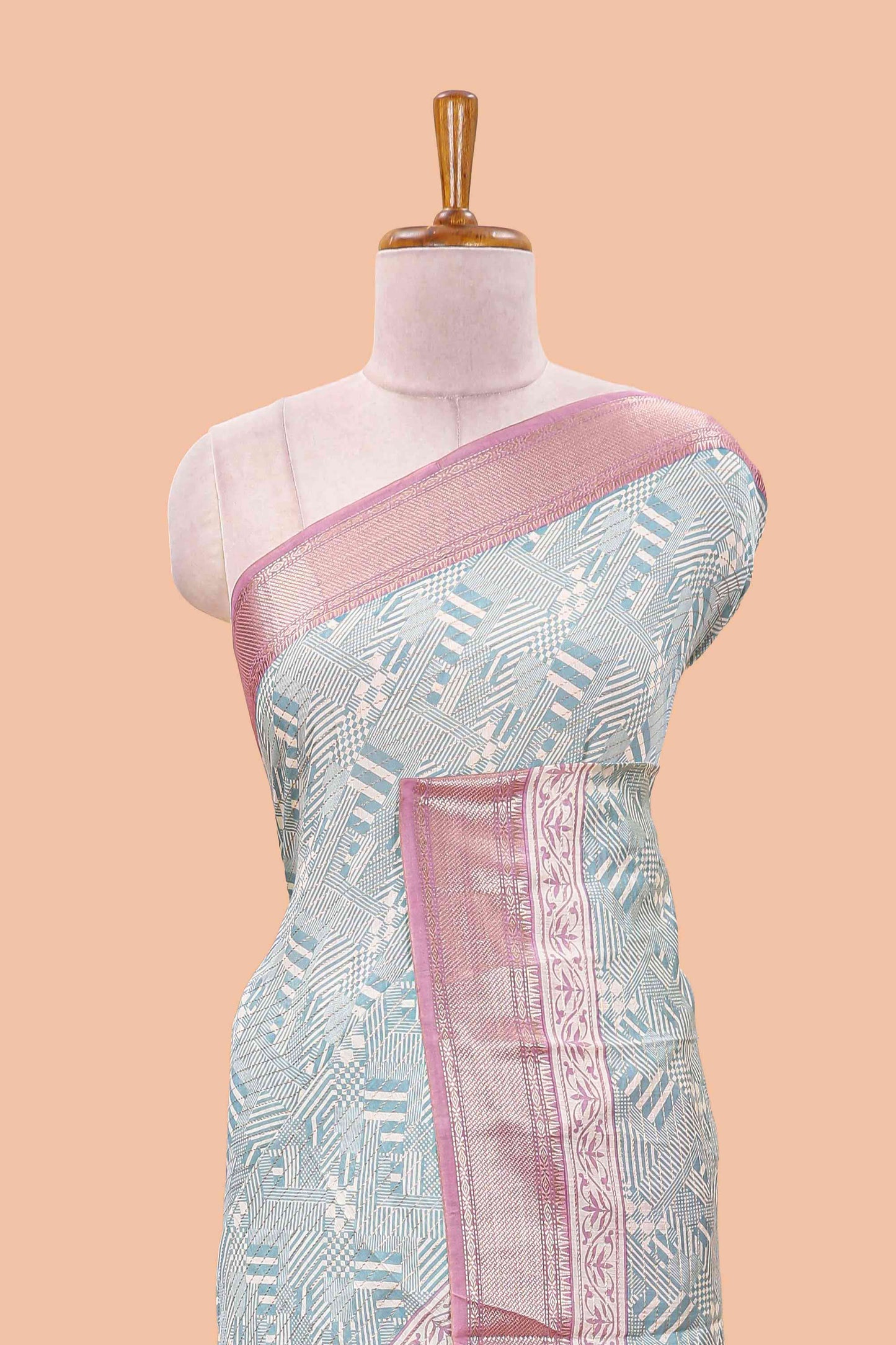 Turquoise blue assam silk saree with geometric print body, contrast zari border, and zari stripe pallu