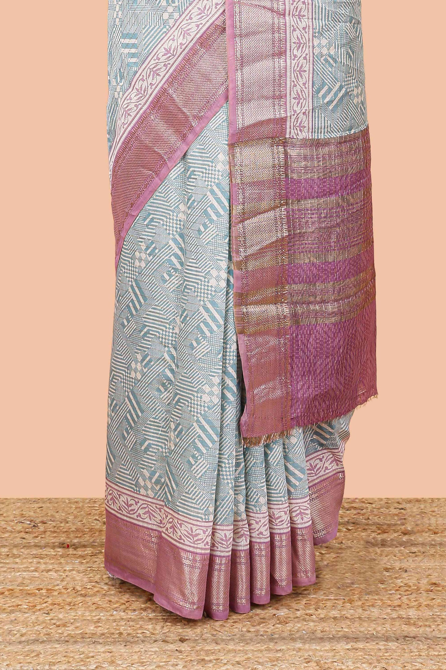 Turquoise blue assam silk saree with geometric print body, contrast zari border, and zari stripe pallu