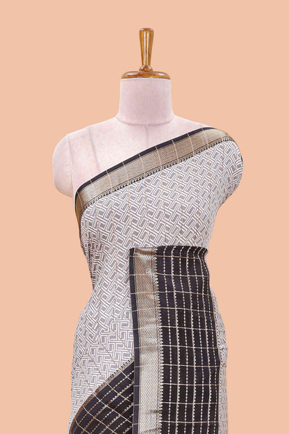 Grey assam silk saree with geometric print, contrast border with zari checks, and Pallu