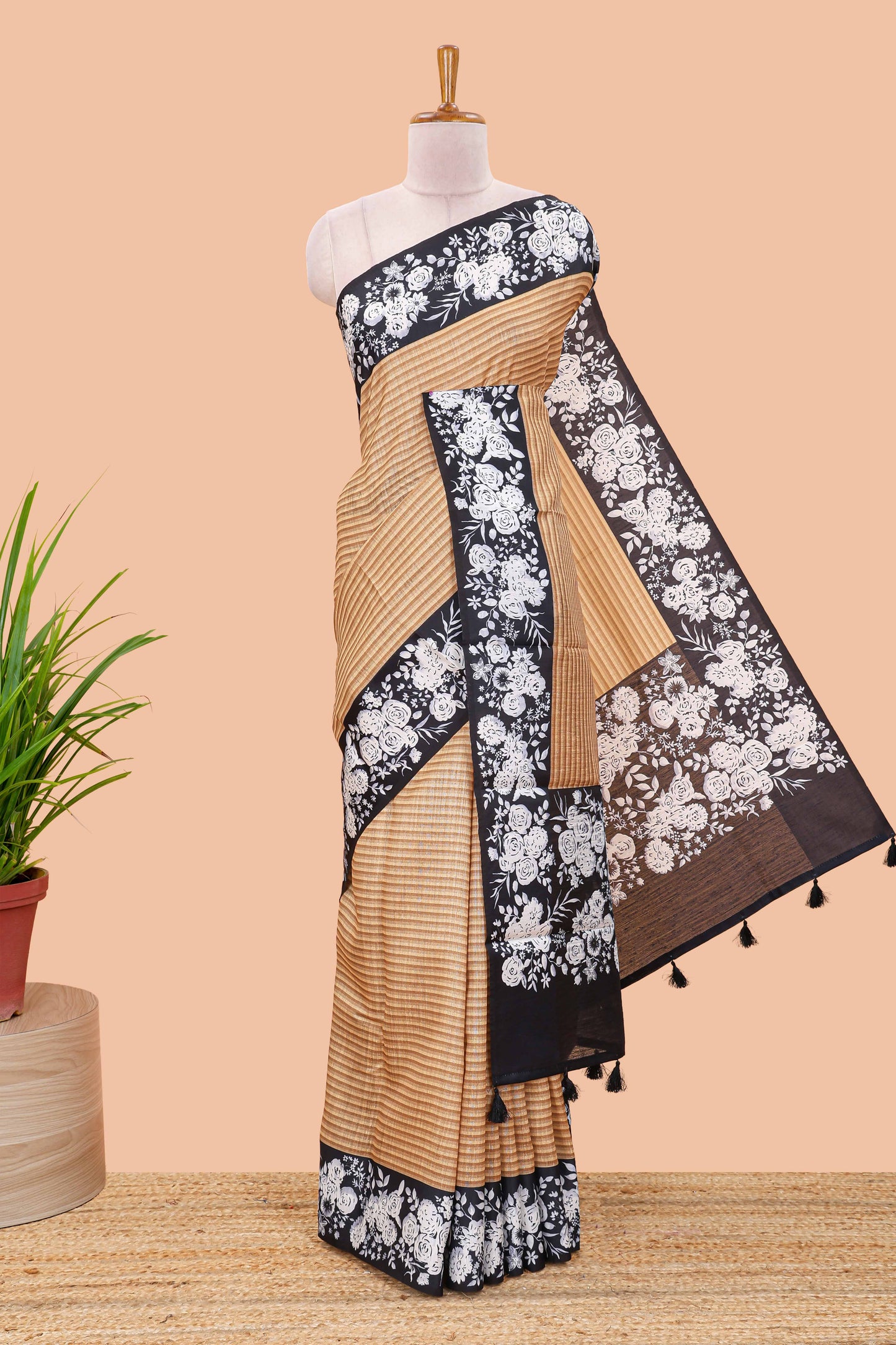 Orange linen cotton saree with all-over stripe print and black satin border with floral print pallu