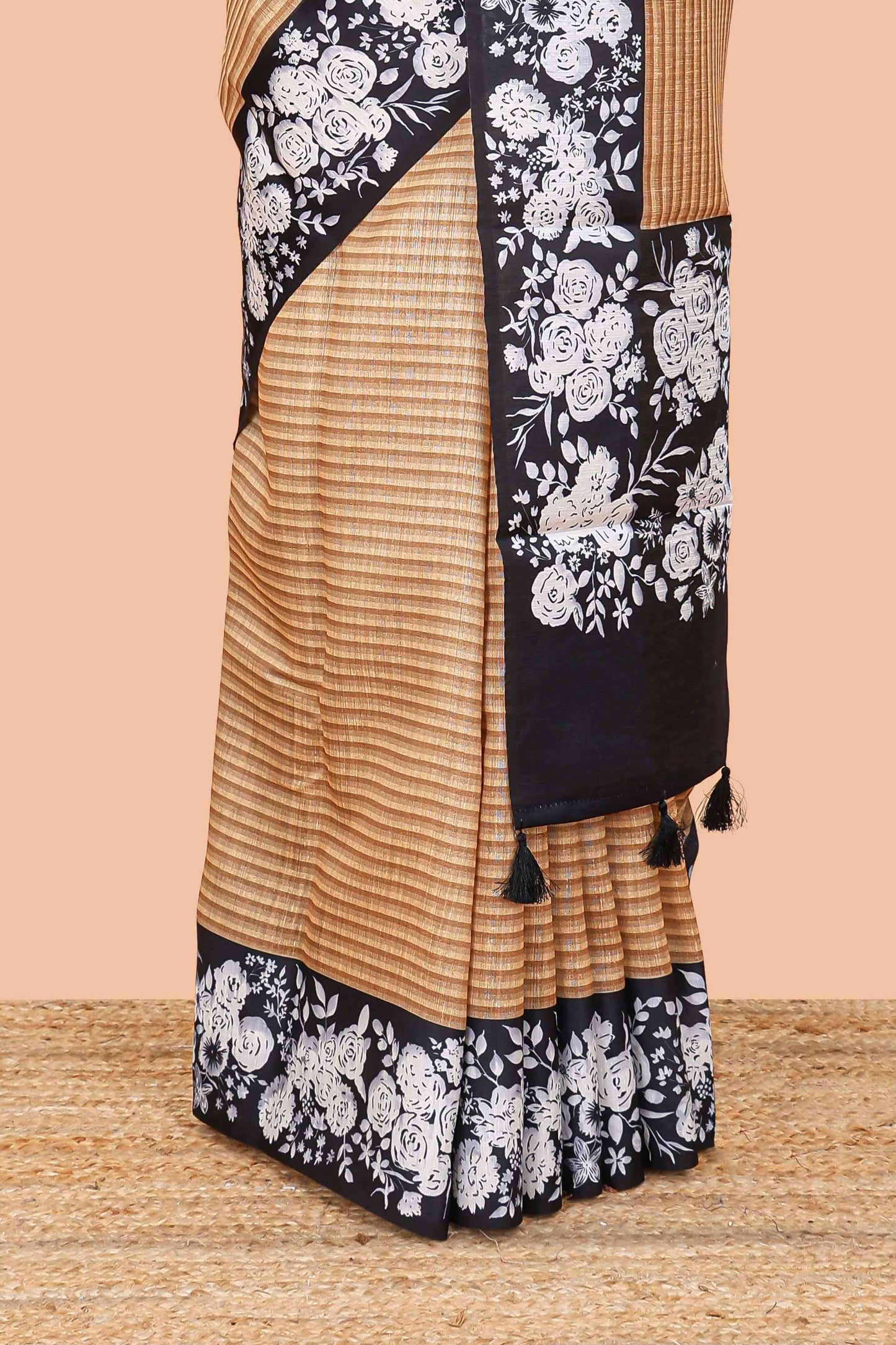 Orange linen cotton saree with all-over stripe print and black satin border with floral print pallu