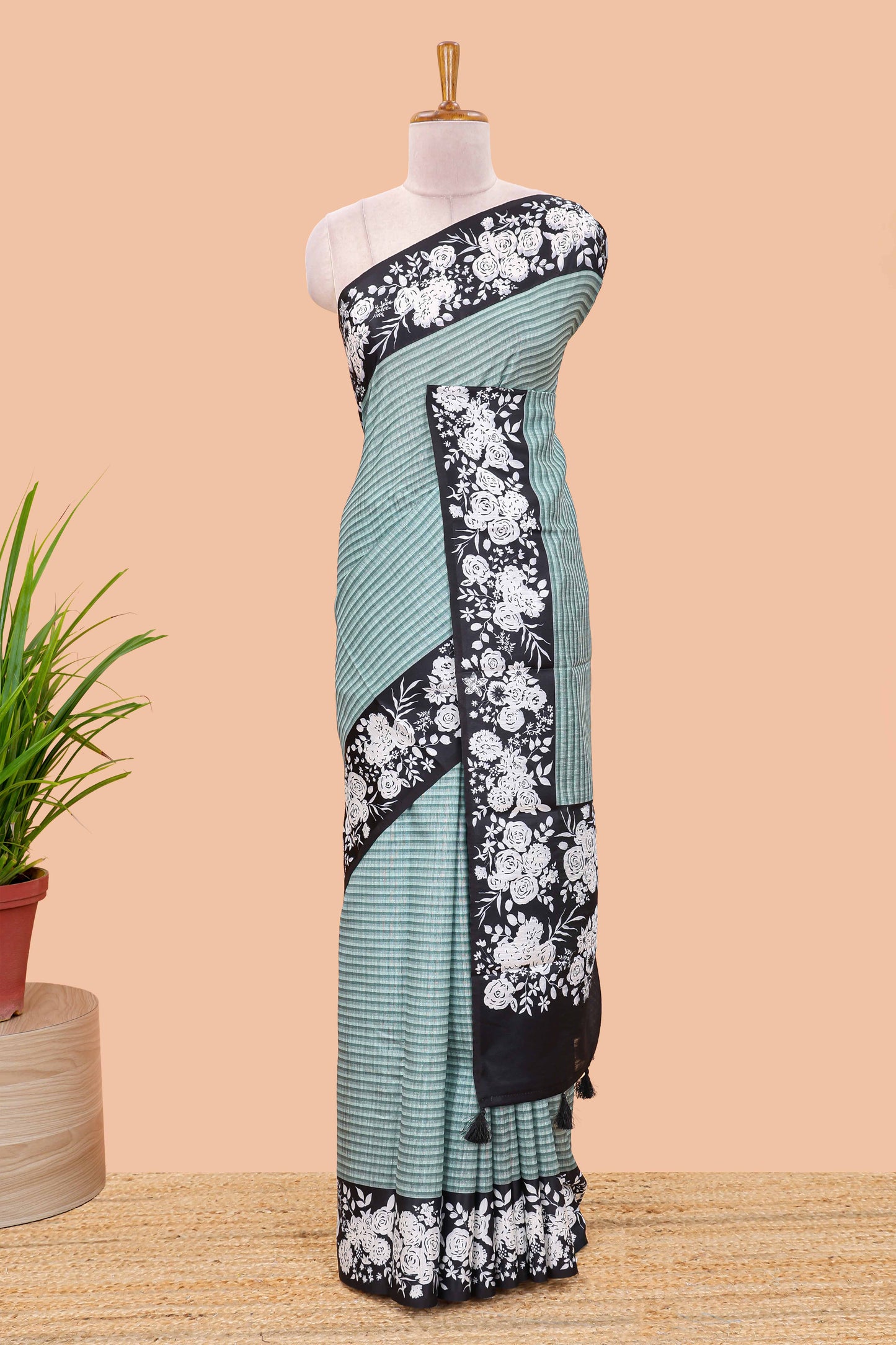 Green linen cotton saree with all-over stripe print and black satin border with floral print pallu