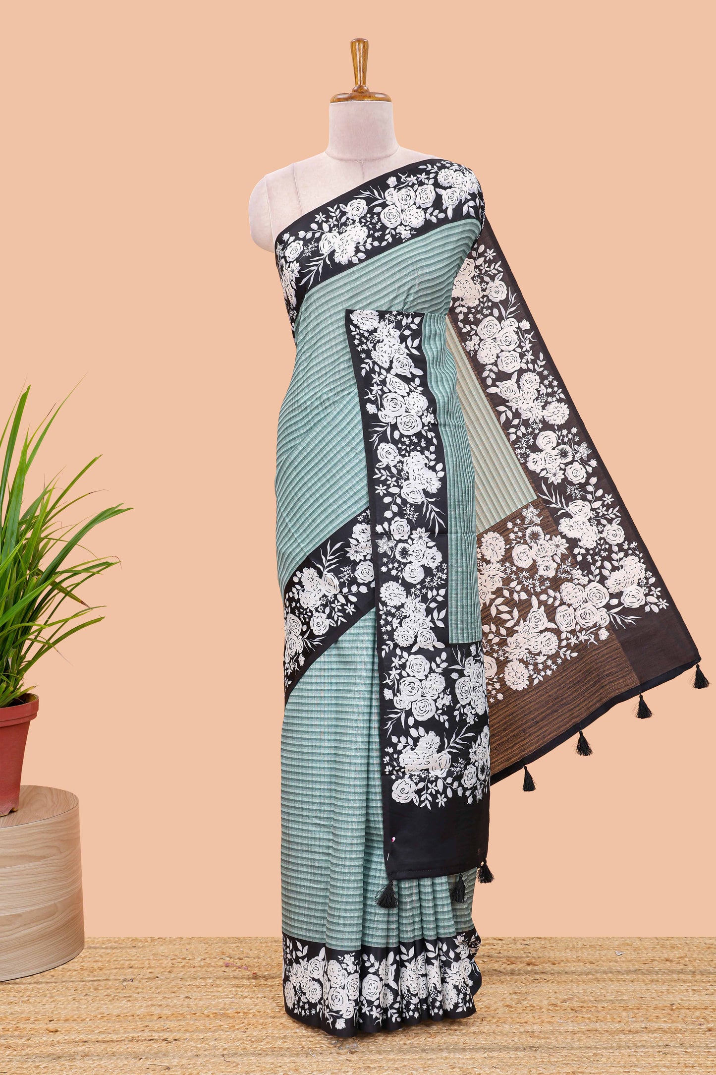 Green linen cotton saree with all-over stripe print and black satin border with floral print pallu