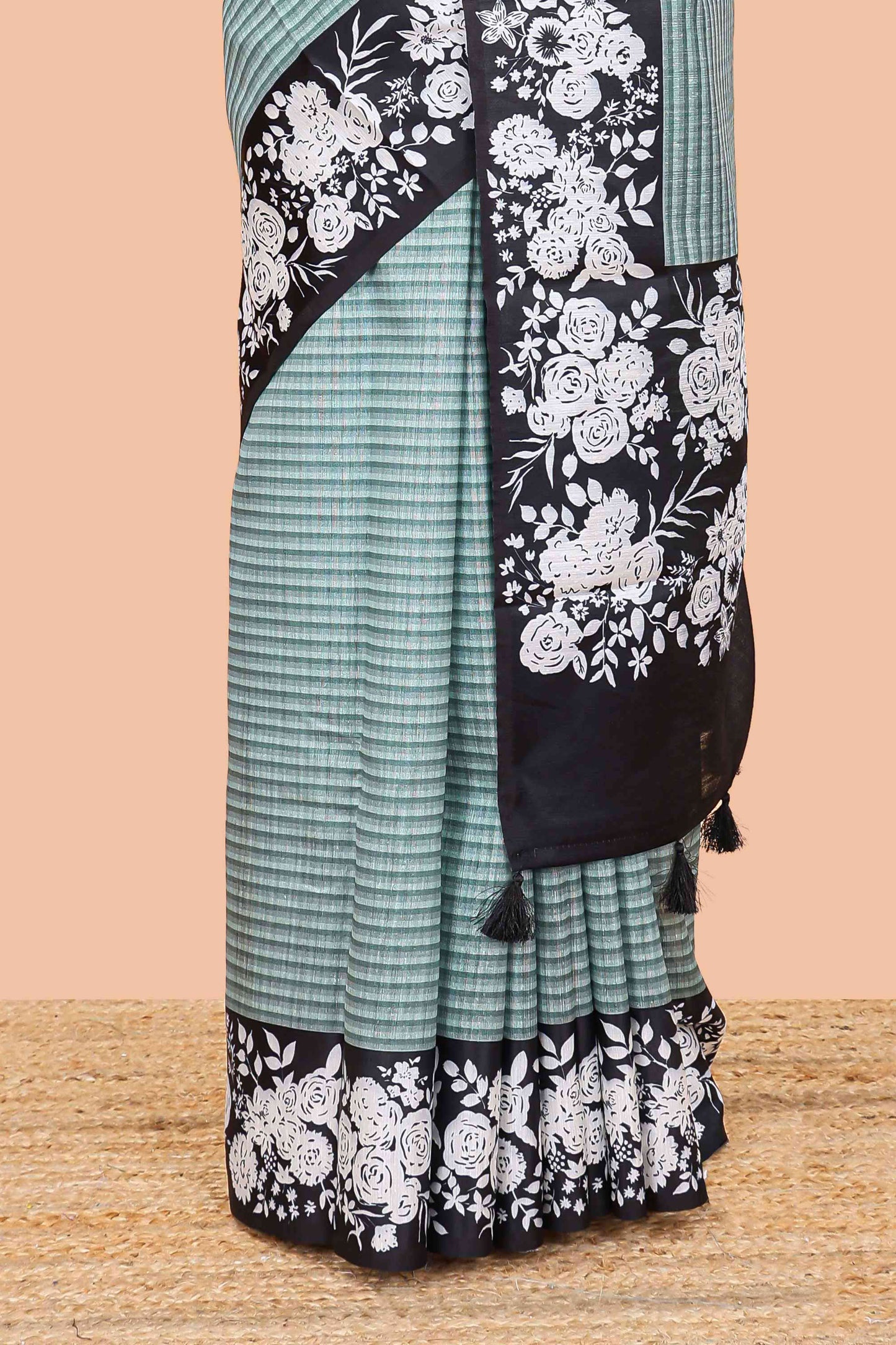 Green linen cotton saree with all-over stripe print and black satin border with floral print pallu