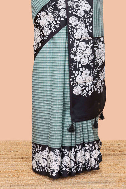 Green linen cotton saree with all-over stripe print and black satin border with floral print pallu