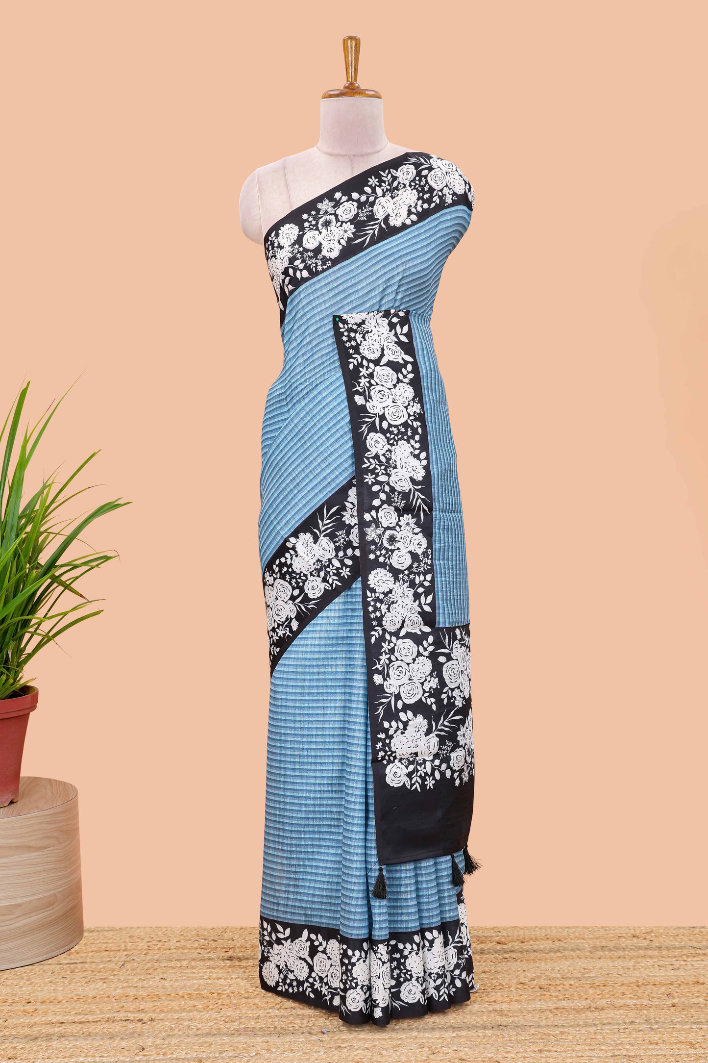 Blue linen cotton saree with all-over stripe print and black satin border with floral print pallu
