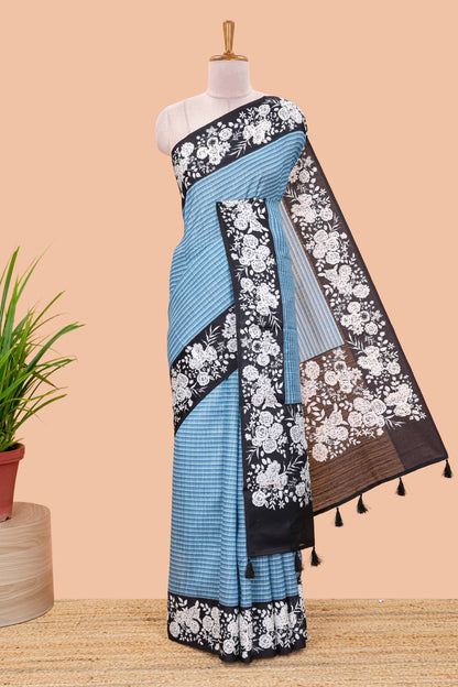 Blue linen cotton saree with all-over stripe print and black satin border with floral print pallu