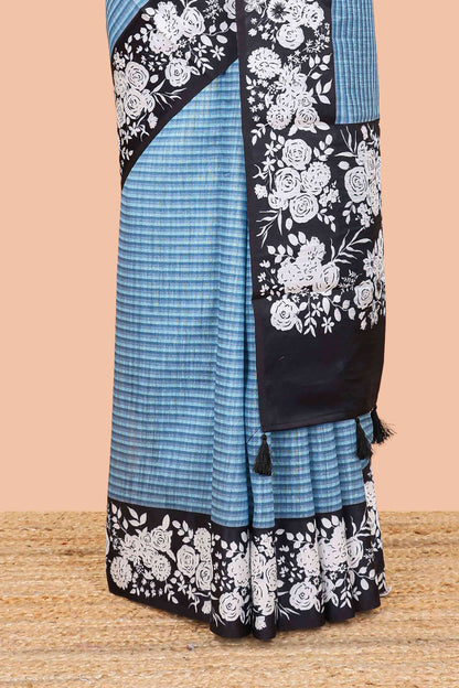 Blue linen cotton saree with all-over stripe print and black satin border with floral print pallu
