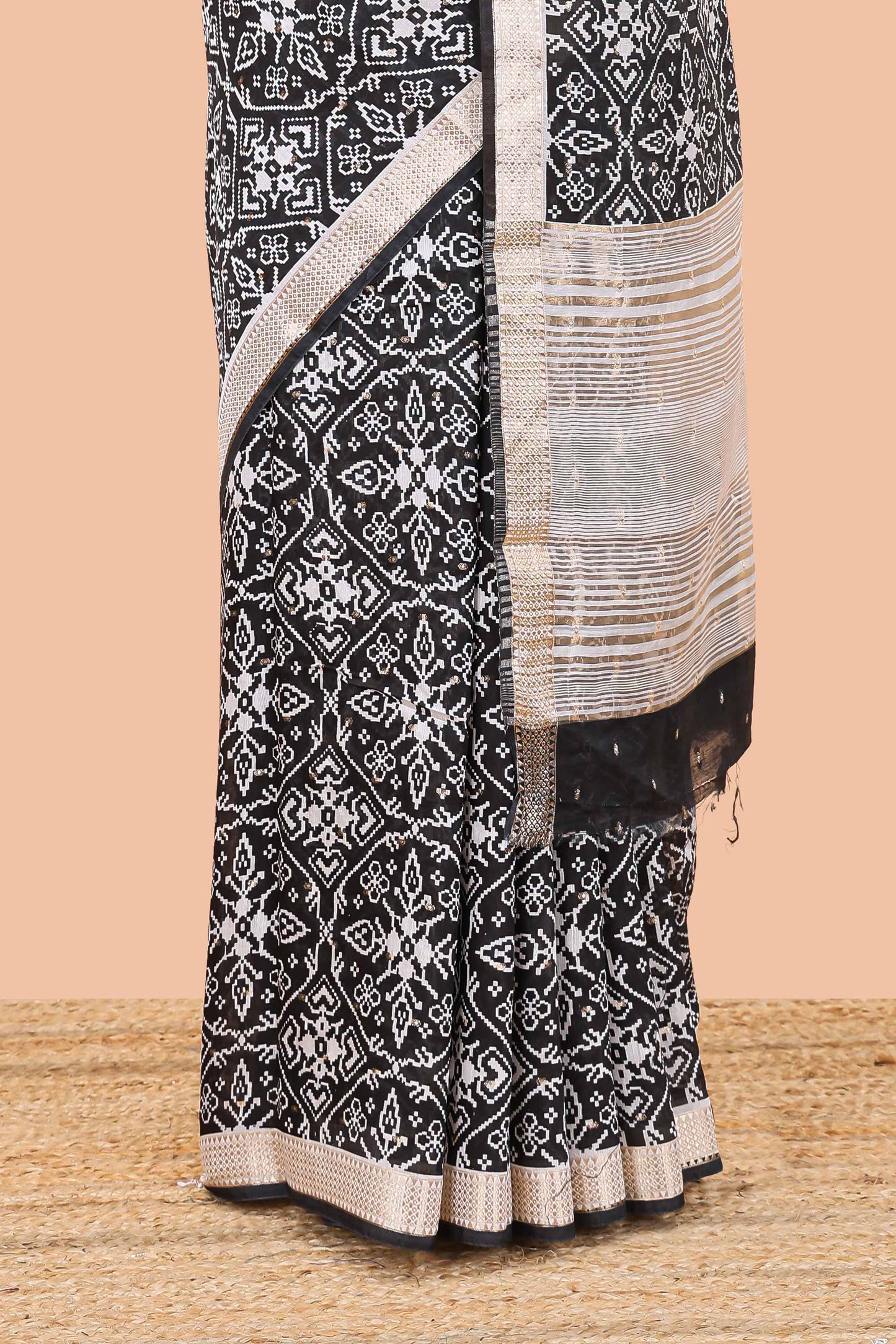 Black assam silk saree with all over ikkat style print, stripe pallu and zari border