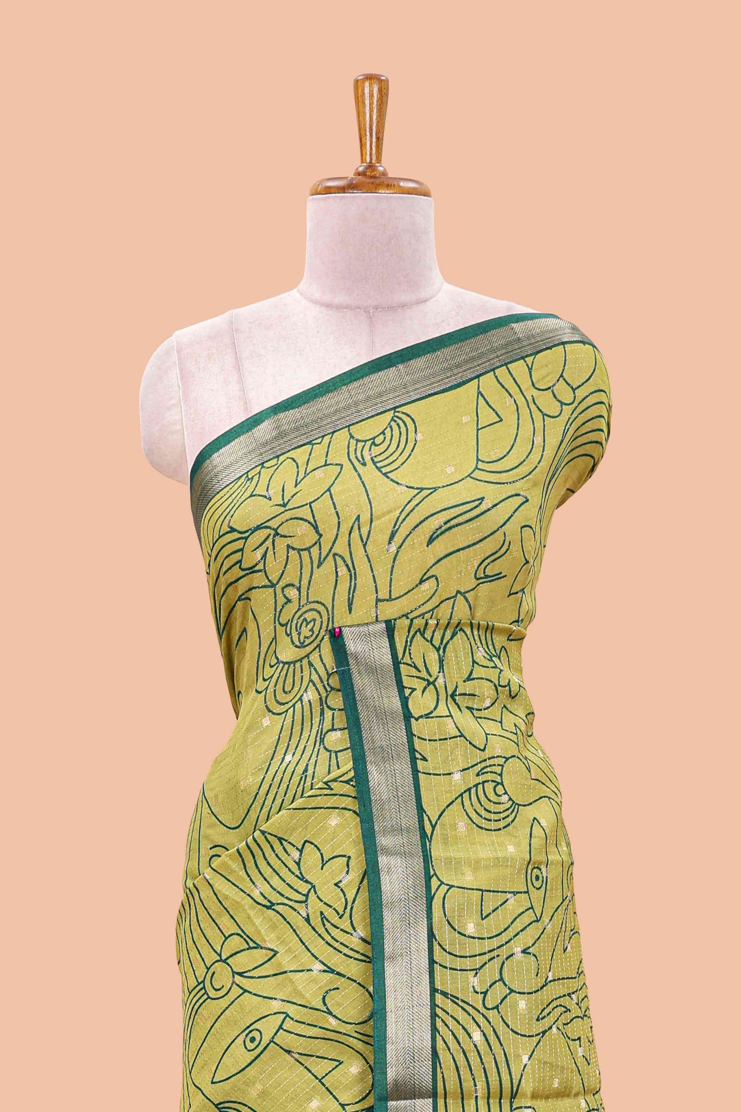 Green assam silk abstract face print saree with contrast zari border and pallu