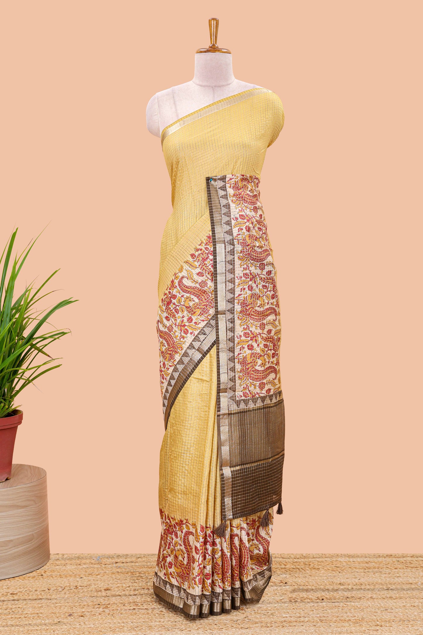 Mustard assam silk saree with zari check, floral & peacock motifs, kalamkari print border and striped pallu
