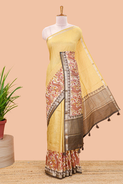 Mustard assam silk saree with zari check, floral & peacock motifs, kalamkari print border and striped pallu
