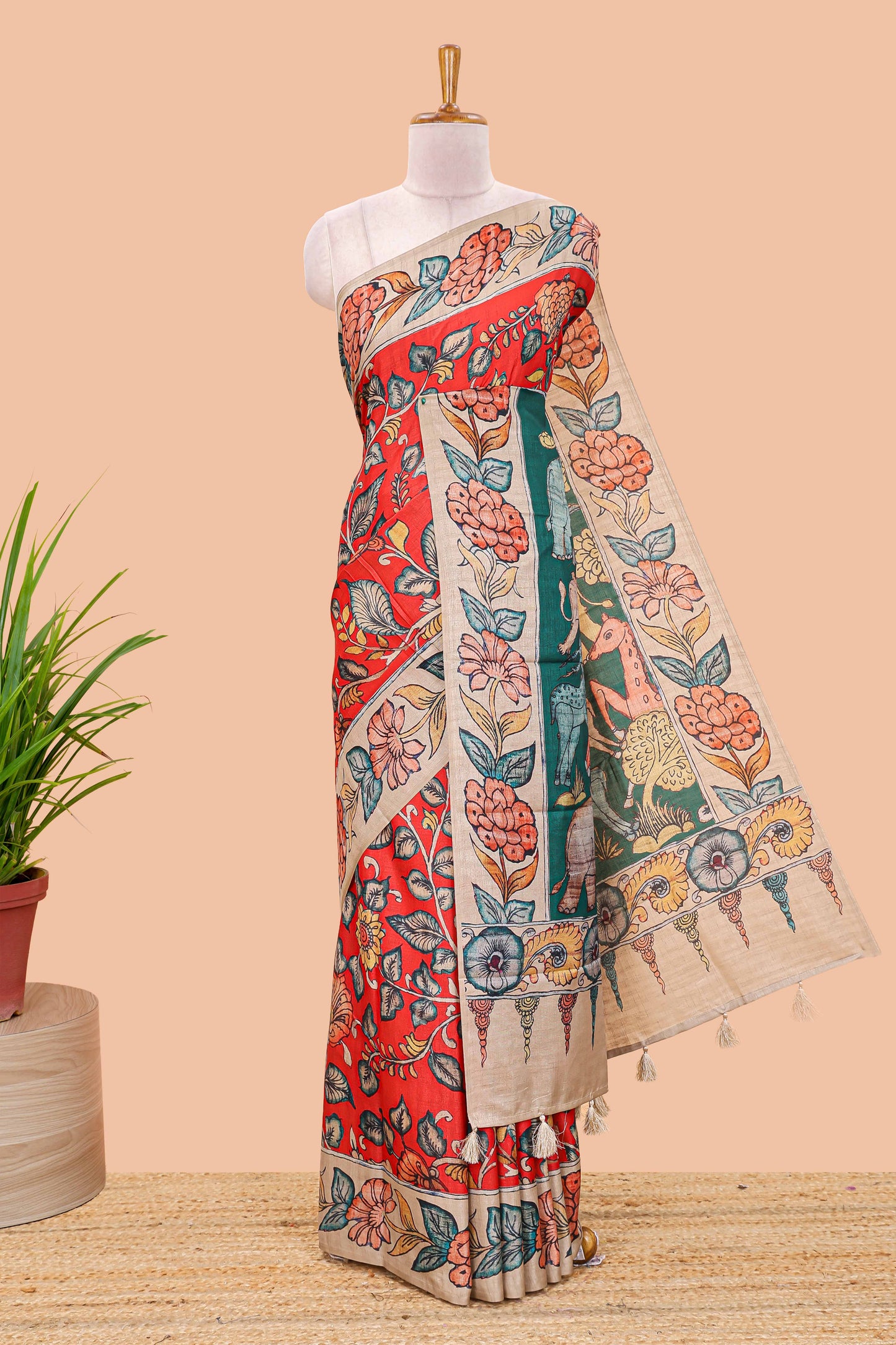 Red art tussar silk saree with leaf and floral printed body, cream border, and floral & animal print pallu