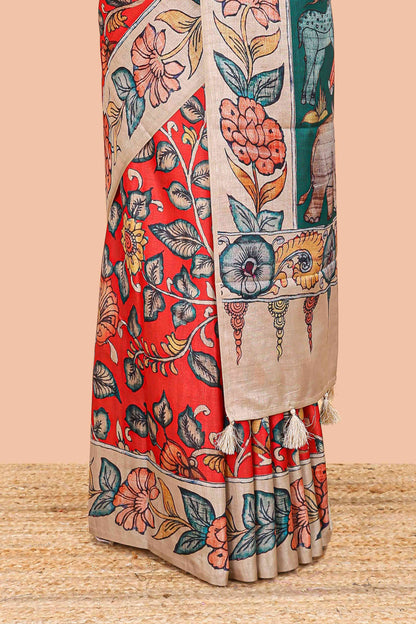 Red art tussar silk saree with leaf and floral printed body, cream border, and floral & animal print pallu