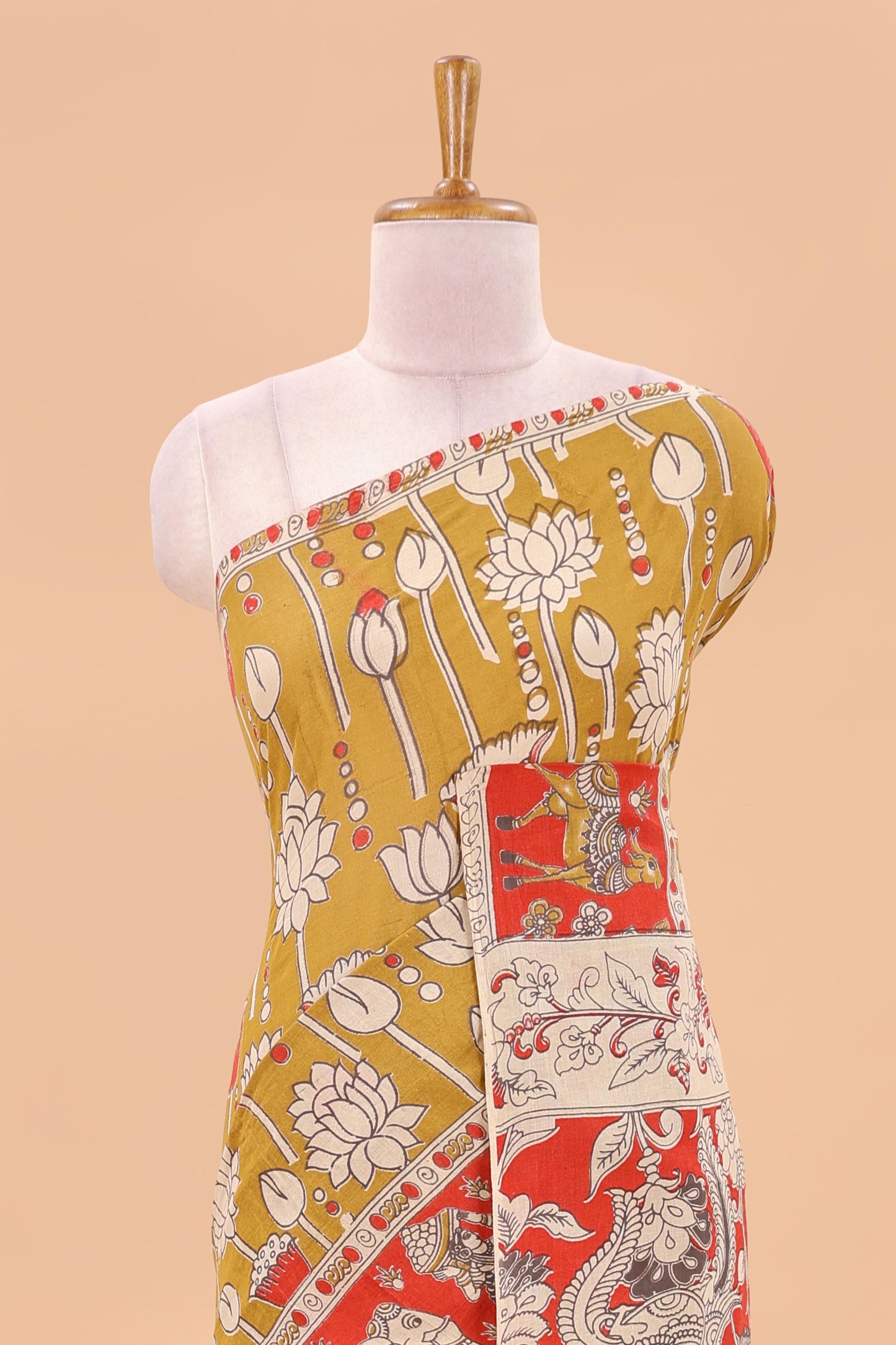 Mustard kalamkari printed cotton saree with traditional floral motifs and contrast pallu