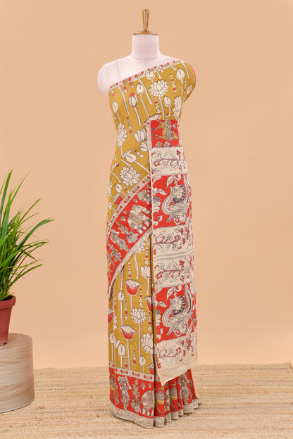 Mustard kalamkari printed cotton saree with traditional floral motifs and contrast pallu
