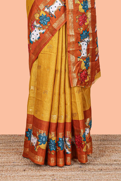 Mustard elephant zari butta art tussar silk saree with contrast pichwai cow double zari border