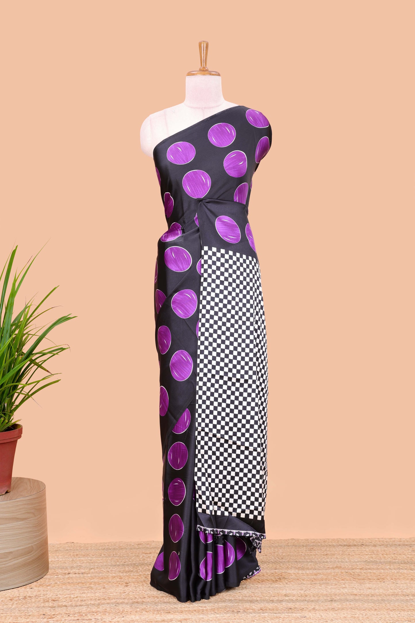Black satin modal saree with purple polka print, contrast checked pallu, and printed blouse