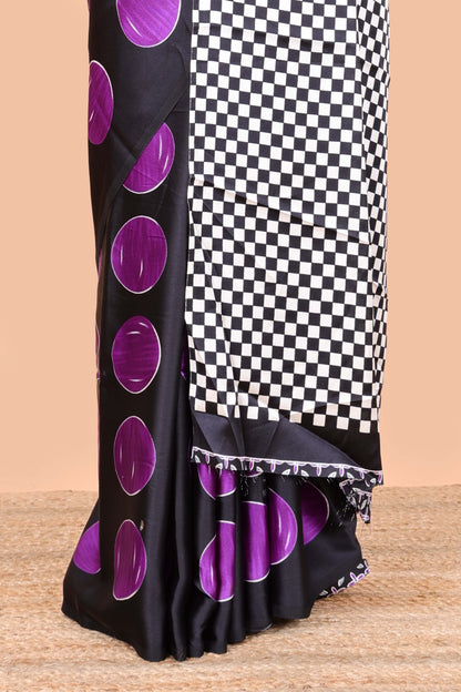 Black satin modal saree with purple polka print, contrast checked pallu, and printed blouse