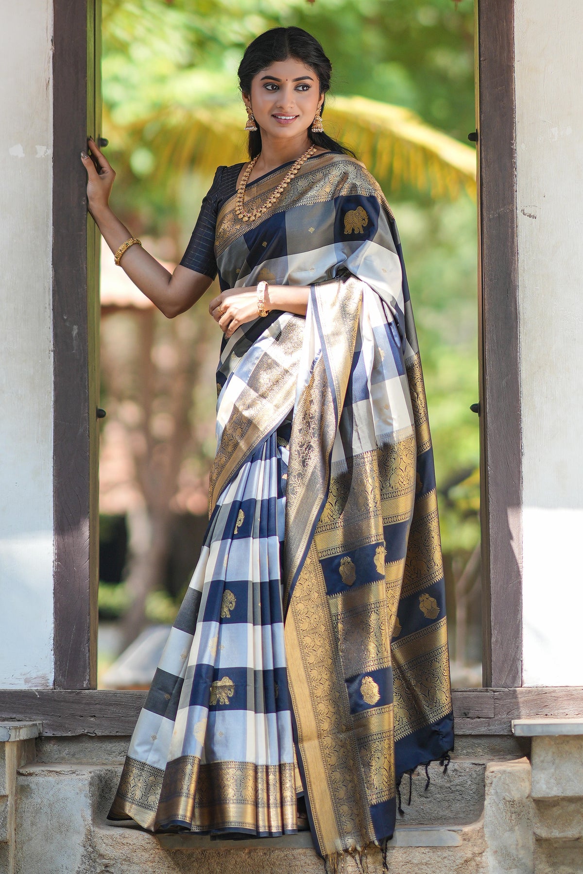 Black and white checked elephant motifs art silk saree with contrast self zari border and matching blouse