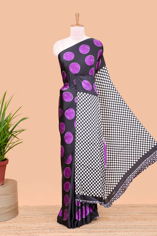 Black satin modal saree with purple polka print, contrast checked pallu, and printed blouse