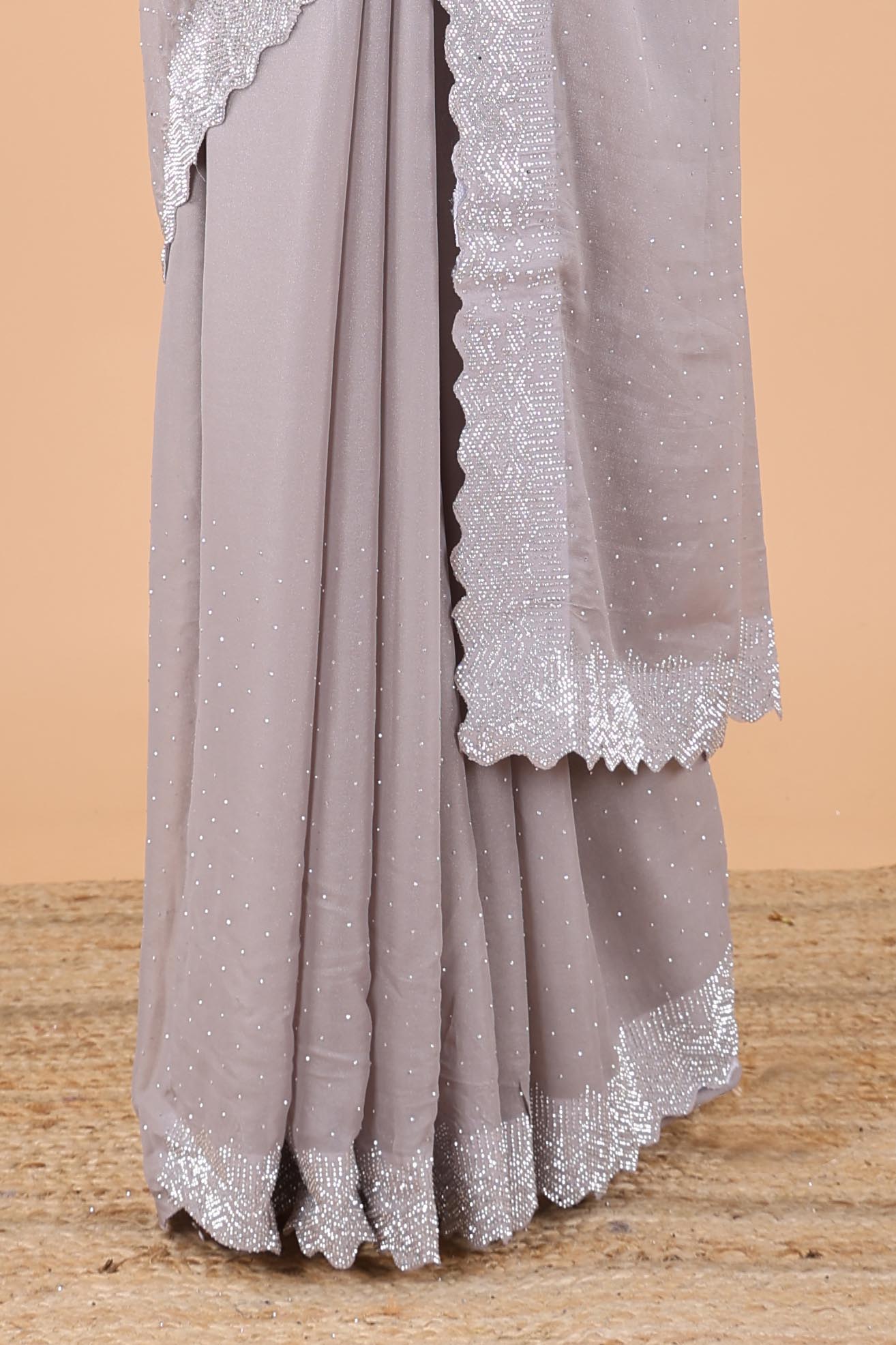 Grey designer georgette space silk saree with heavy stone & beads work, short pallu and contrast sequin embroidered blouse