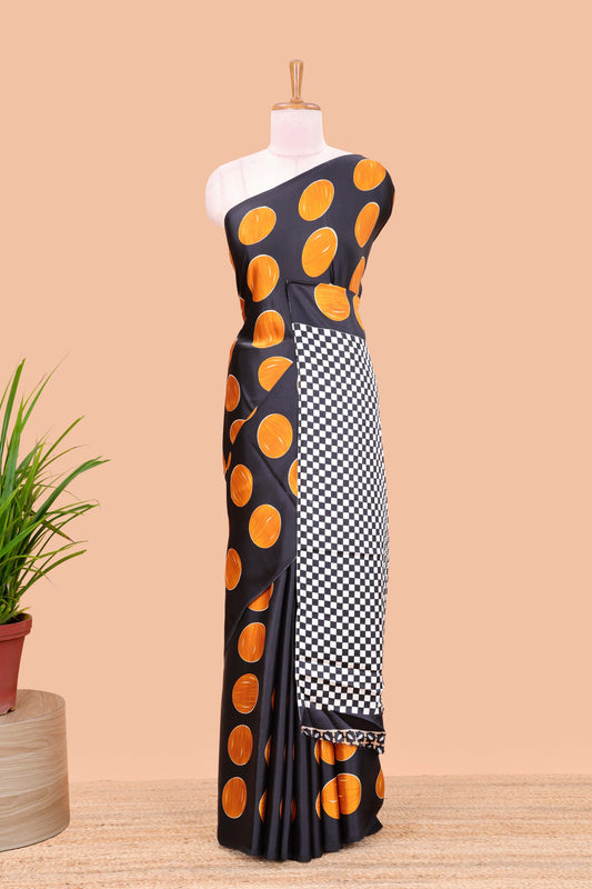 Black satin modal saree with orange polka print, contrast checked pallu, and printed blouse