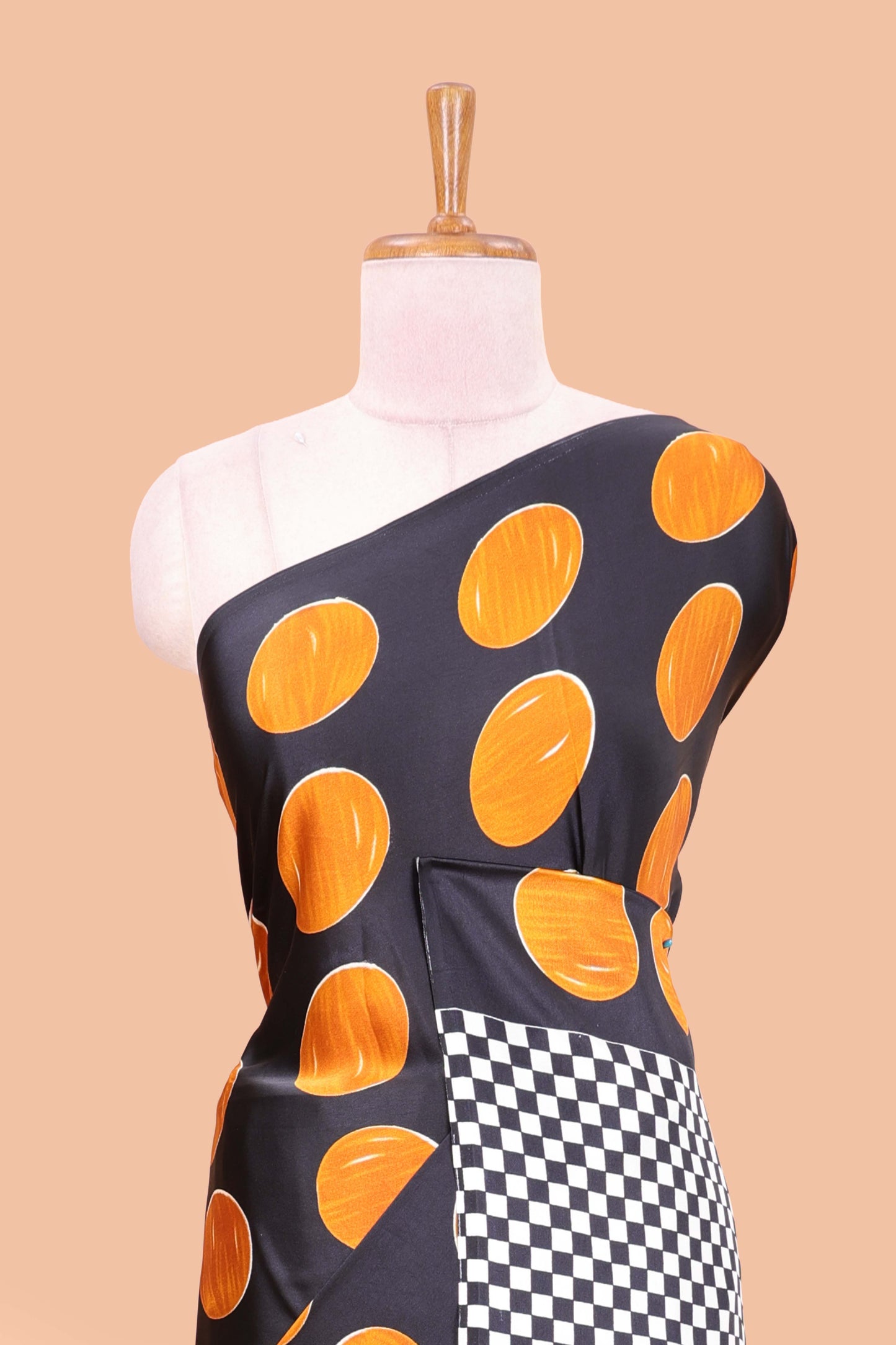 Black satin modal saree with orange polka print, contrast checked pallu, and printed blouse