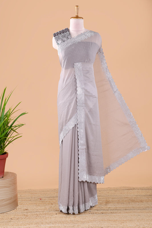 Grey designer georgette space silk saree with heavy stone & beads work, short pallu and contrast sequin embroidered blouse