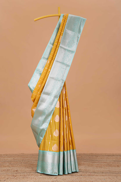 Mustard semi soft silk banarasi style saree with gold zari stripes and contrast border