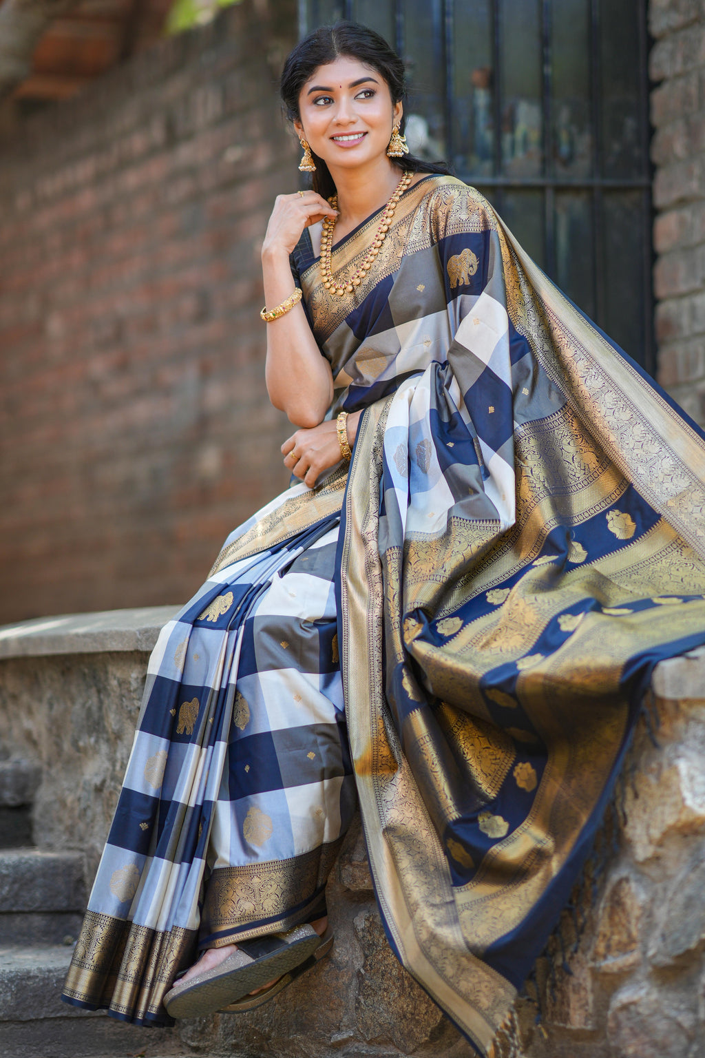 Black and white checked elephant motifs art silk saree with contrast self zari border and matching blouse