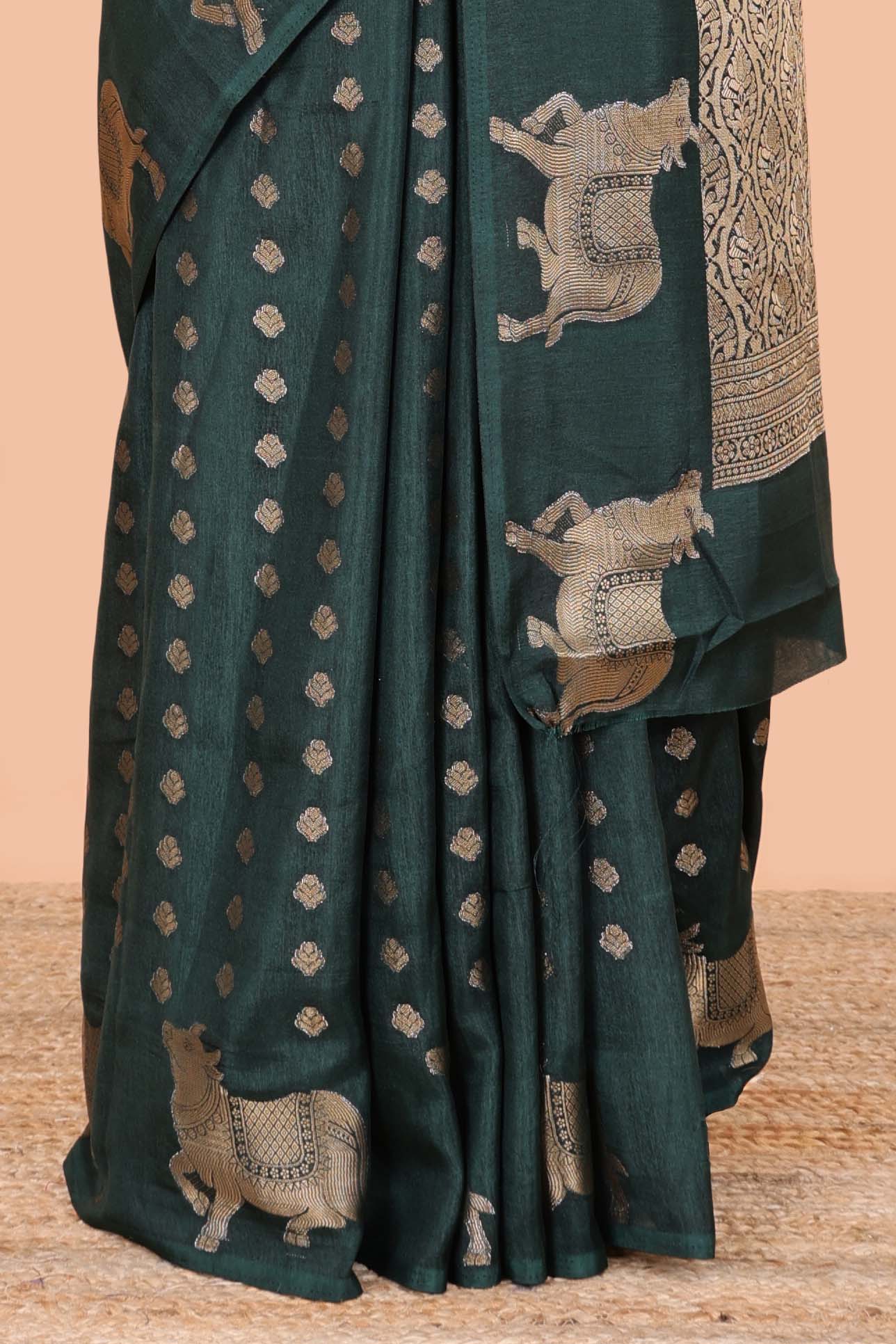 Green viscose dola silk saree with zari butta weave, pichwai motif border and contrast blouse
