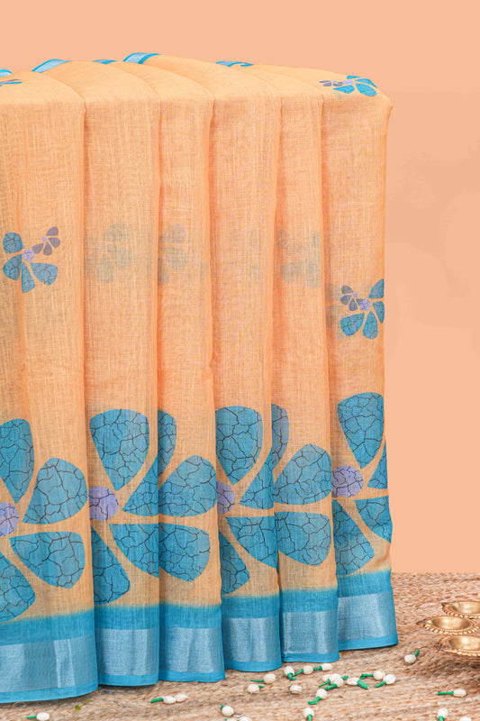 Orange floral printed linen cotton saree with contrast silver zari border, contrast pallu and blouse