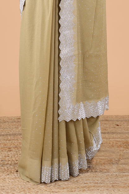 Green designer georgette space silk saree with heavy stone & beads work, short pallu and contrast sequin embroidered blouse