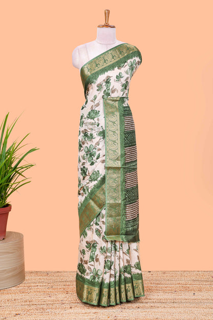 Cream floral design semi dola silk saree with contrast green zari border an blouse