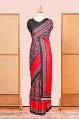 Black Modal Silk Saree The Body Has Ajrakh Design The Pallu Are Highlighted Vibrant Red Colour Along With Blouse