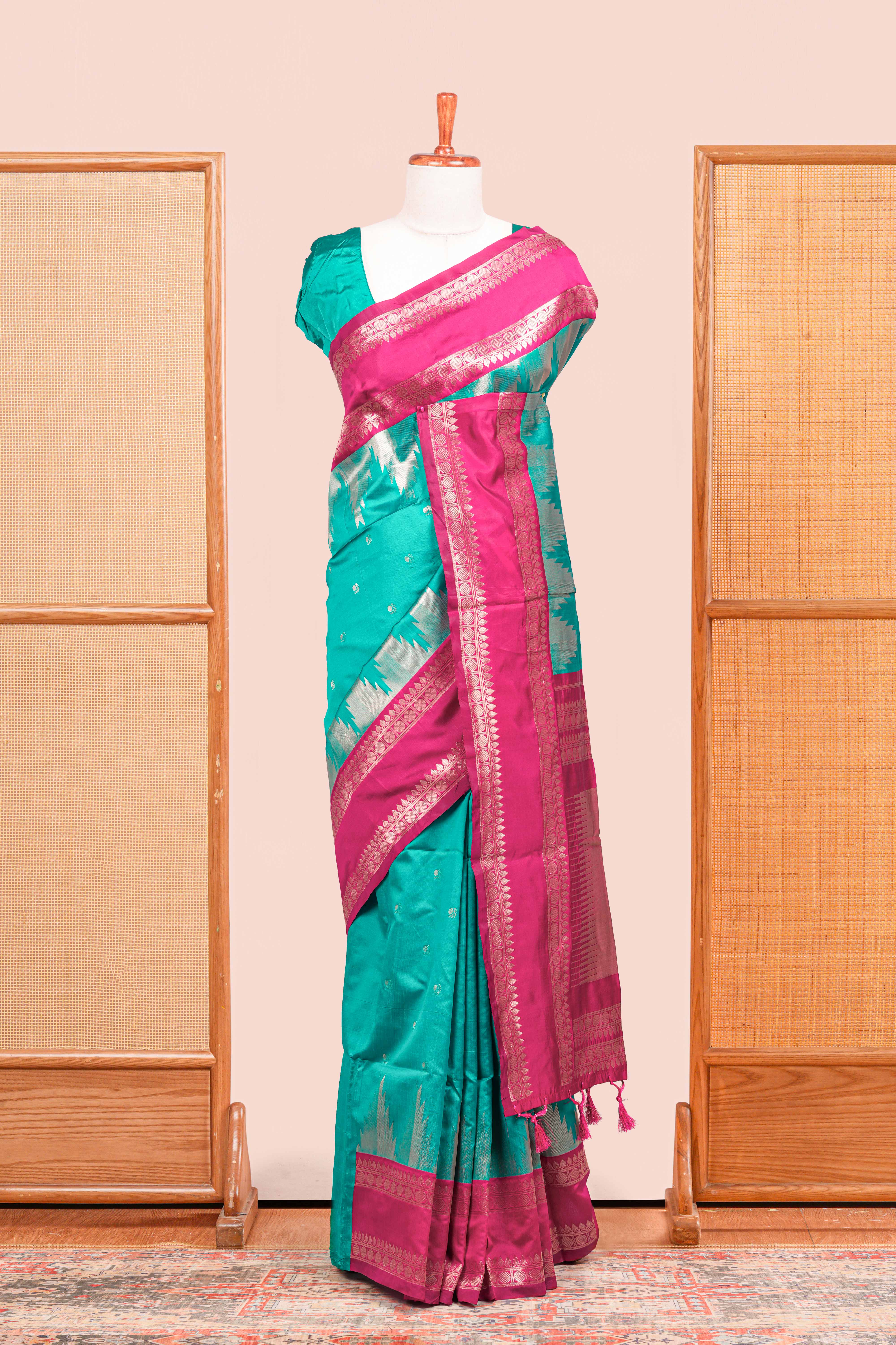 Rama Green Semi Art Silk Saree Delicate Golden Zari Motifs Along With Thalampoo Zari Woven Across The Body. The Border Is Broad With Intricate Floral Zari Weaving Rich Golden Zari Pallu