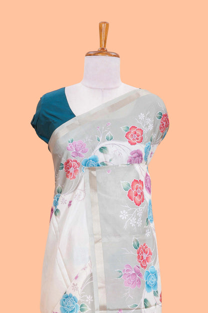 Cream floral vines art tussar saree with contrast pastel green blouse and border