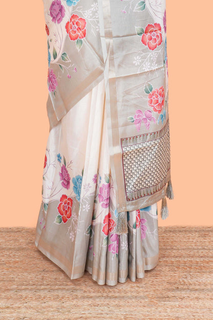 Cream floral vines art tussar saree with contrast pastel green blouse and border