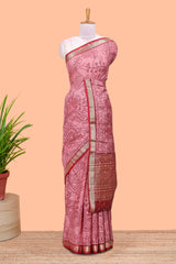 Pink assam silk abstract face print saree with contrast zari border and pallu