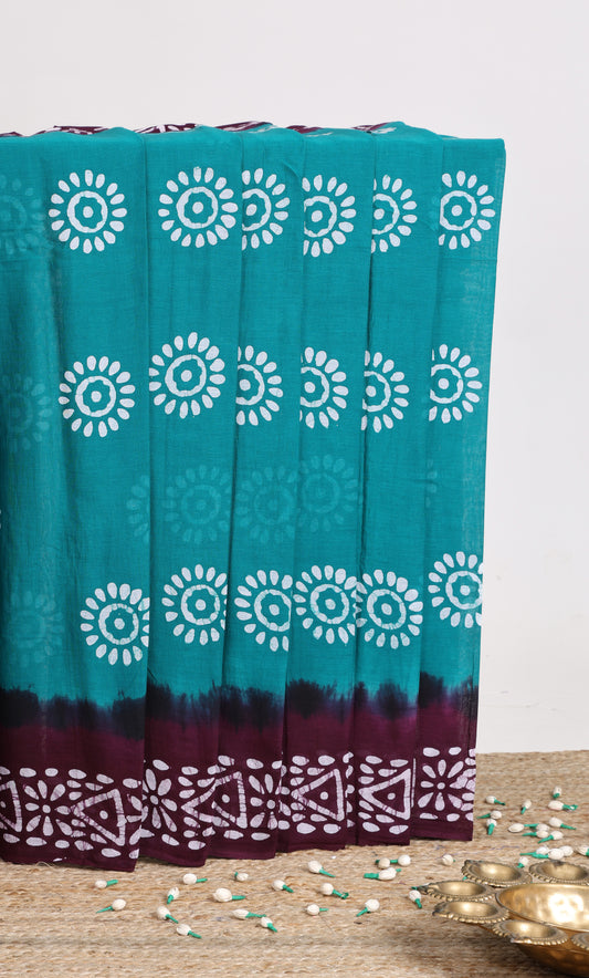 Turquoise green floral batik print sungudi cotton saree with contrast border and batik style pallu