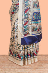 Cream south cotton saree with green kalamkari print on body, pallu contrast blue blouse
