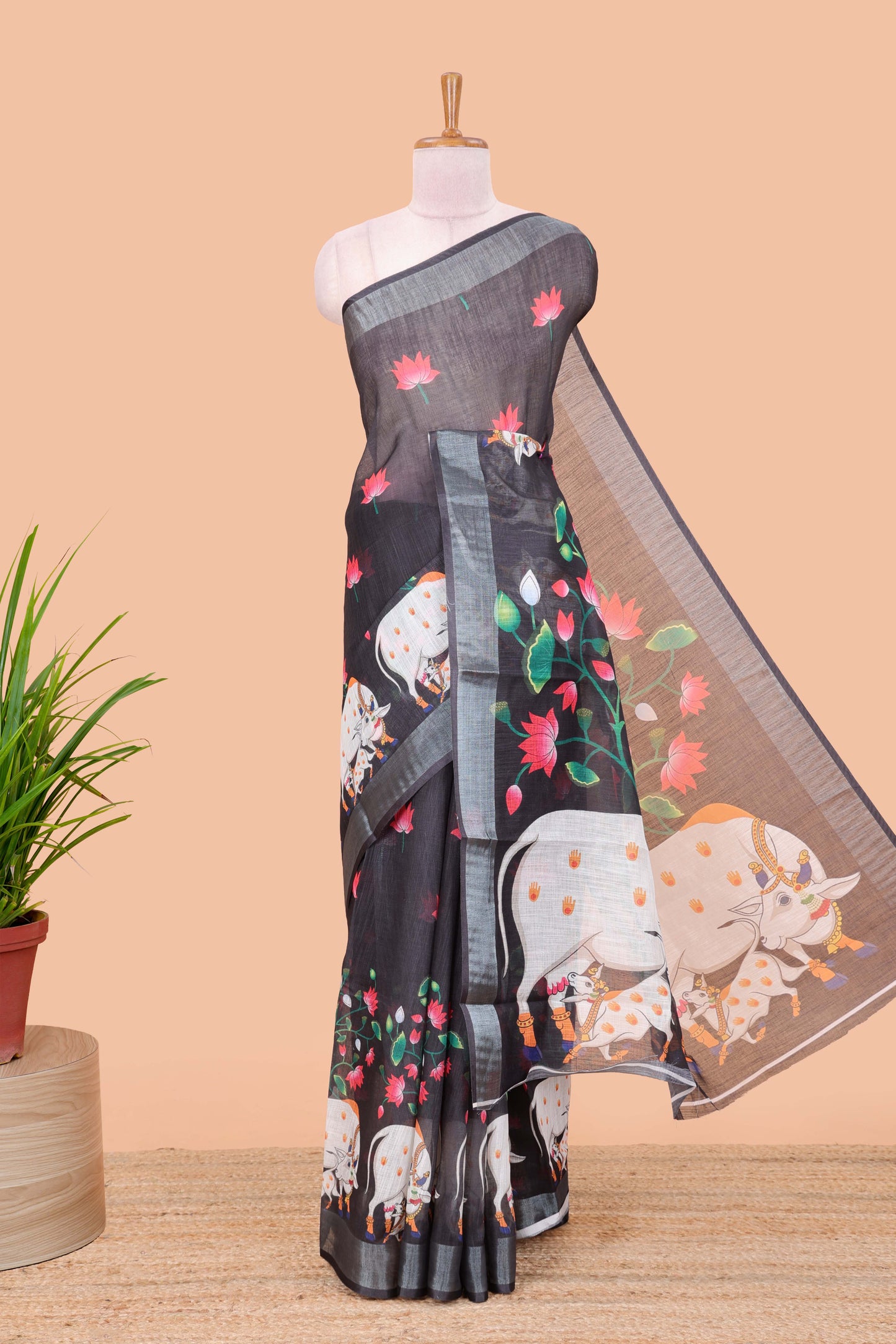 Black linen floral and animal themed print saree with zari border