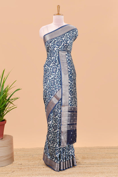 Cream chanderi cotton saree with floral vines, contrast zari border and striped pallu