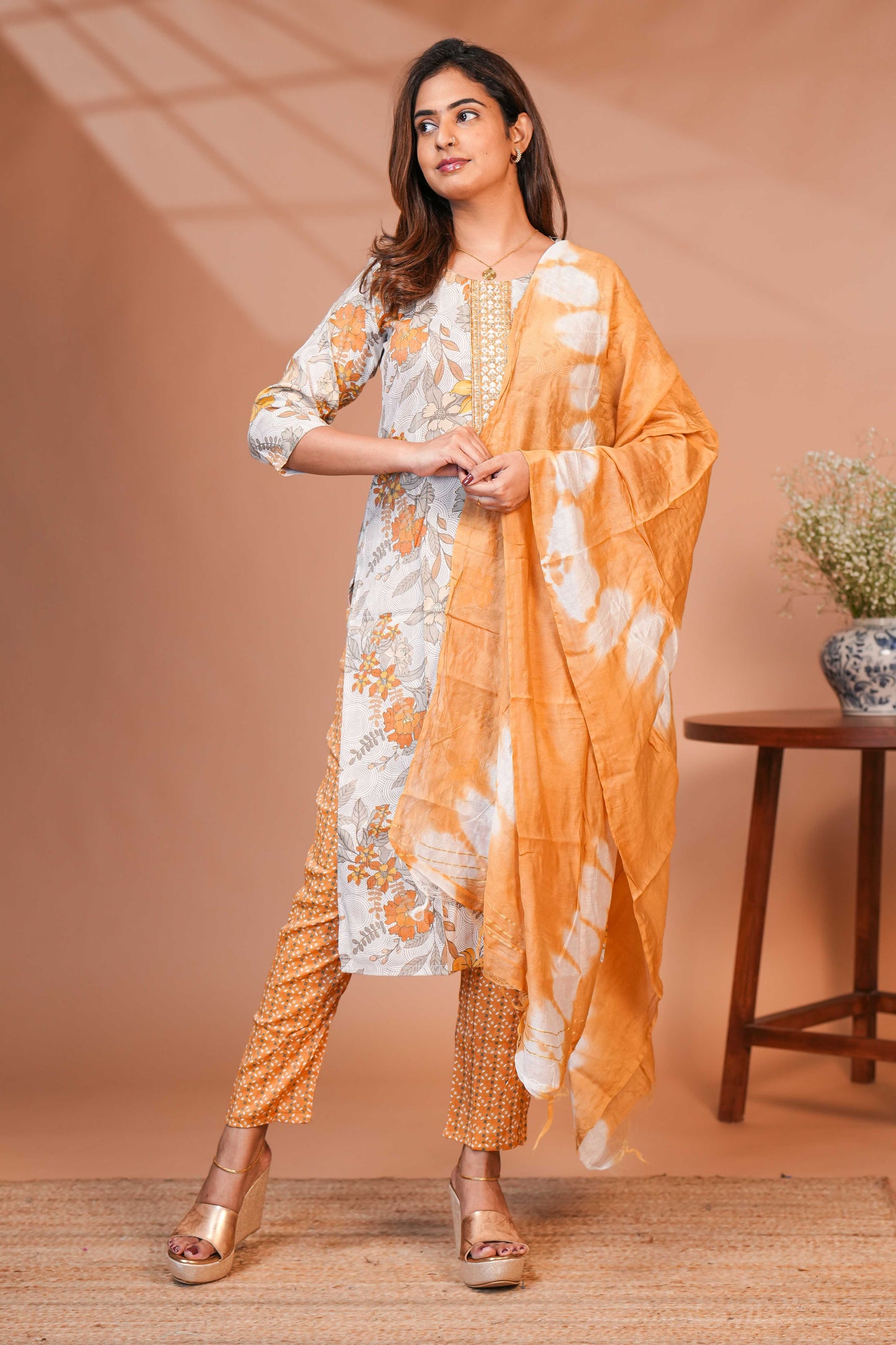 Orange floral design chamki work round neck salwar set with 3/4th sleeve, self bottom and matching dupatta