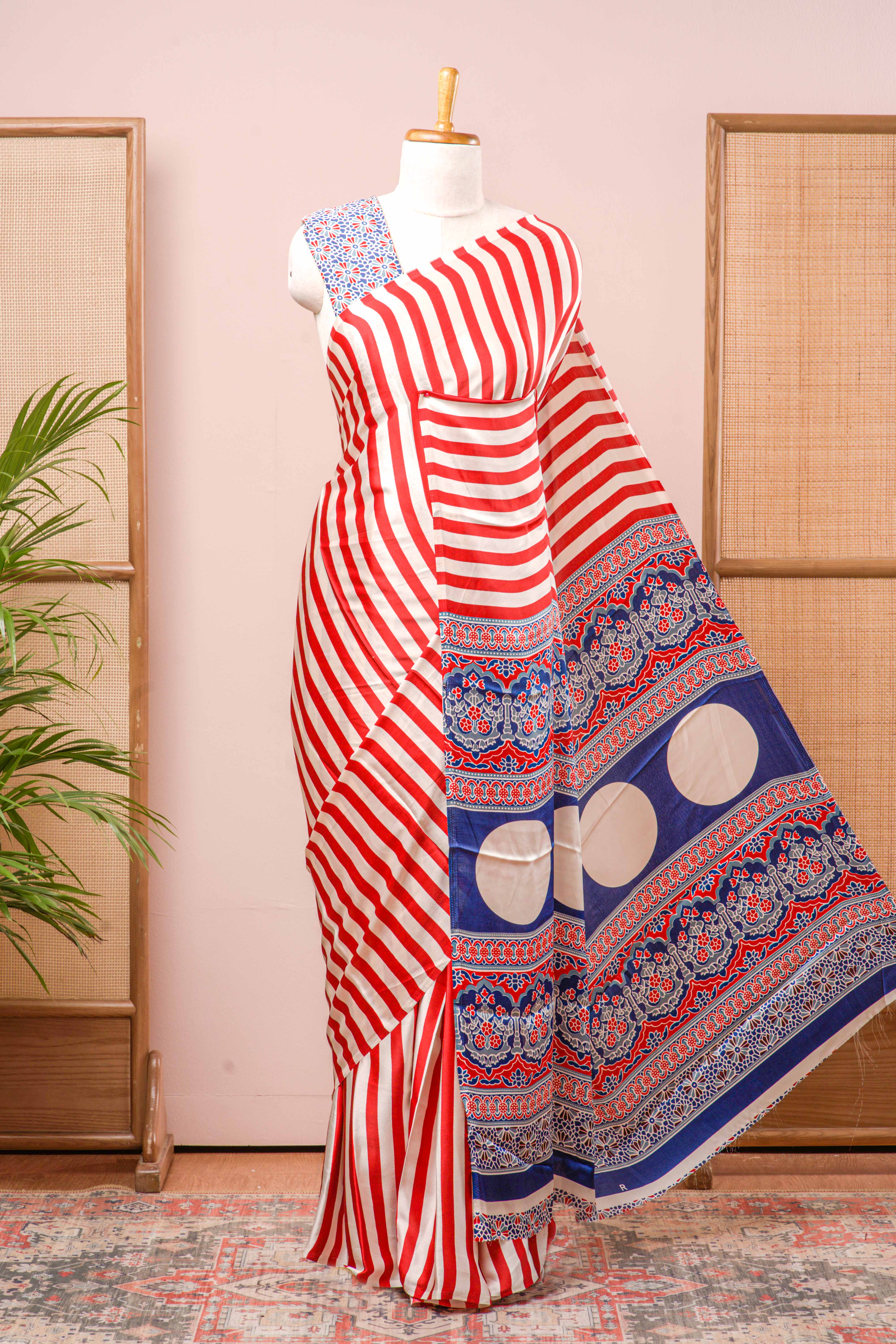 White Modal Silk Saree Body Detailing Contrast Red Vertical Stripes That Add a Sleek and Elegant Touch. The Pallu Are Highlighted Ajrakh Design Along With Blouse