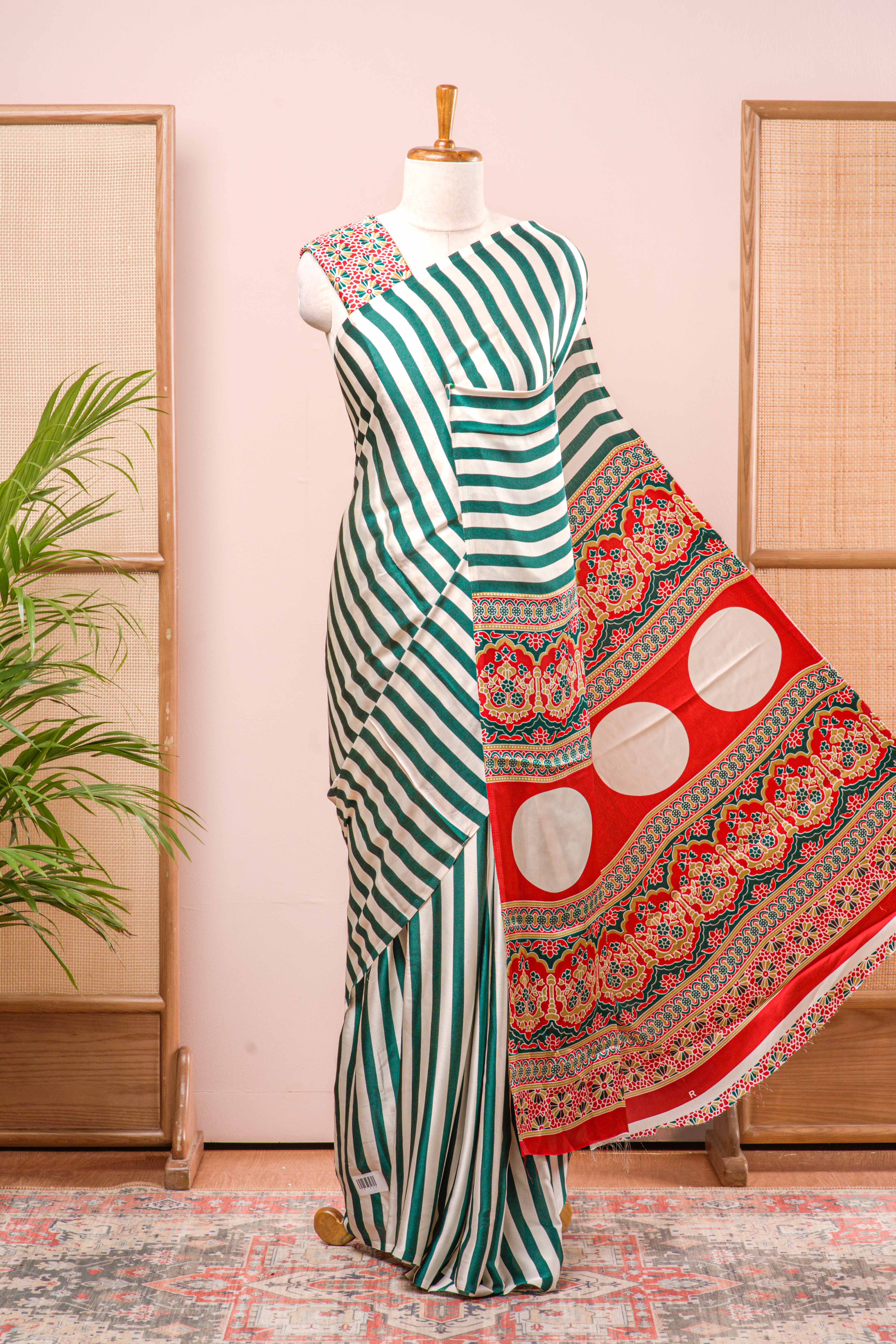 White Modal Silk Saree Detailing Vertical Green Stripes That Add a Sleek and Elegant Touch. Highlighted Contrast Ajrakh Print Pallu Along With Blouse